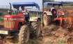 Dhoni is seen driving a tractor in the fields.- India TV Paisa