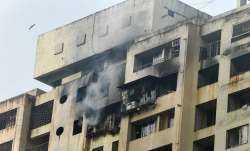 Smoke billows out after a blaze on the 18th floor of Kamla building in Tardeo area of Mumbai, Saturd- India TV Paisa