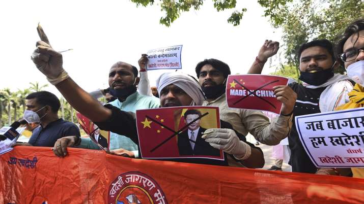 Members of ruling Bharatiya Janata Party sit in front of India Gate monument in New Delhi, India, holding candles as tributes to Indian soldiers killed during confrontation with Chinese soldiers in the Ladakh region. 