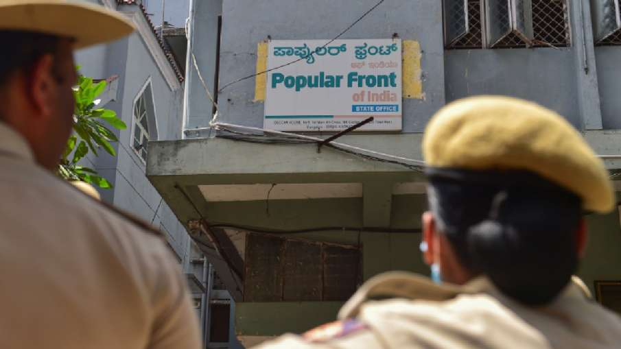 Security personnel stand guard outside the People's Front (PFI) party office in Bengaluru