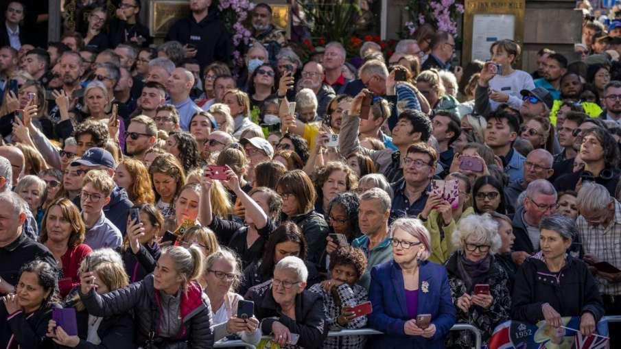 People attend the procession of Queen Elizabeth IIs coffin from the Palace of Holyroodhouse to St Gi