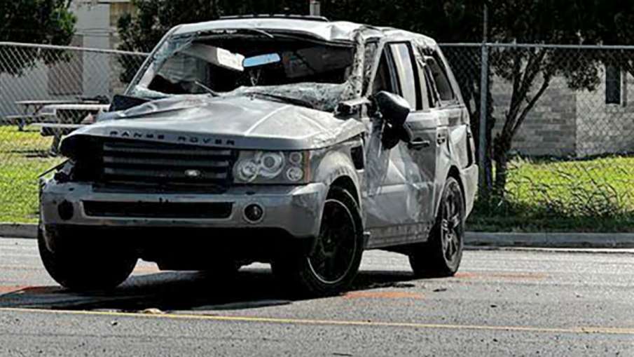 A damaged vehicle sits at the site of a deadly collision near a bus stop in Brownsville