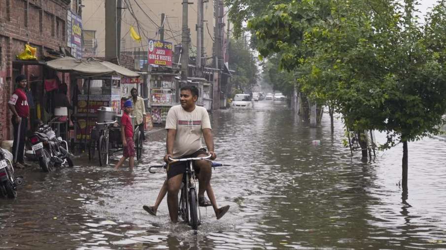 Cycle rider goes amidst waterlogging