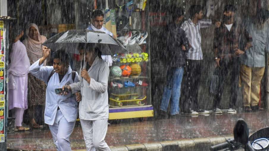 People go amid heavy rains