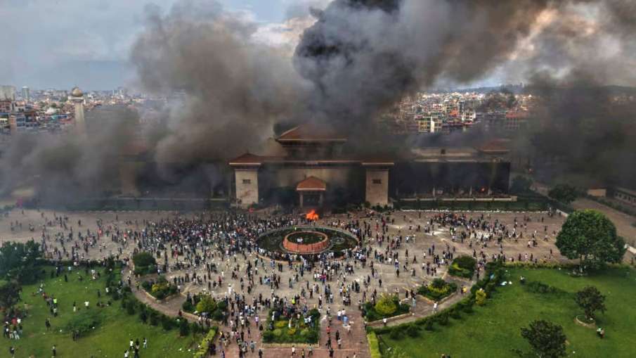 हिंसा का शिकार होने के बाद नेपाल के सिंह दरबार से उठता काला धुआं और आग की लपटें।