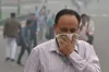 A pedestrian covers his face with a handkerchief for...- India TV Hindi