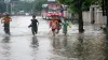 Children play at a waterogged road following heavy monsoon rain in Varanasi- India TV Hindi