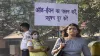 Civil Defence volunteer wearing a mask displays a placard asking people to obey the odd-even rule, i- India TV Hindi
