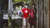 Visitors wear protective masks outside the Special...- India TV Paisa
