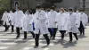 Wuhan: Medical workers from Beijing walk near a park during...- India TV Hindi