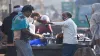 People buy tea from a roadside vendor as temperatures drop in the city, in New Delhi.- India TV Hindi