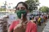 A voter, wearing face mask, shows her ink-marked finger...- India TV Hindi