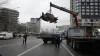 Workers load the debris of a rocket onto a truck the aftermath of Russian shelling in Kyiv, Ukraine,- India TV Hindi