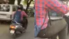 चलती स्कूटी पर काम करते हुए शख्स- India TV Hindi