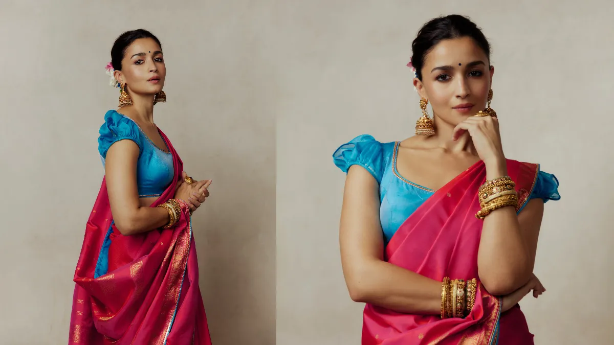 चटख गुलाबी रंग के साथ गोल्डन बॉर्डर का कॉम्बिनेशन बेहद आकर्षक लग रहा था। अभिनेत्री ने साड़ी को पारंपरिक बंगाली स्टाइल में पहना, जिसमें पल्लू को कंधे पर खास तरीके से सजाया गया था। इससे उनके ब्लाउज की डिजाइन भी खूबसूरती से नजर आई। आलिया ने साड़ी के साथ टरक्वॉइज ब्लू यानी फ़िरोजी रंग का फिटेड ब्लाउज पहना। इसकी गोल नेकलाइन और हल्की पफ स्लीव्स ने पूरे लुक को क्लासी टच दिया। गुलाबी और नीले रंग का कॉन्ट्रास्ट उनके पारंपरिक परिधान को और भी खास बना रहा था। साड़ी के सुनहरे बॉर्डर के साथ ब्लाउज पर की गई बारीक कढ़ाई ने भी लोगों का ध्यान खींचा।