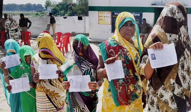 Voters display their voter's ID card at a polling booth for...- India TV Hindi