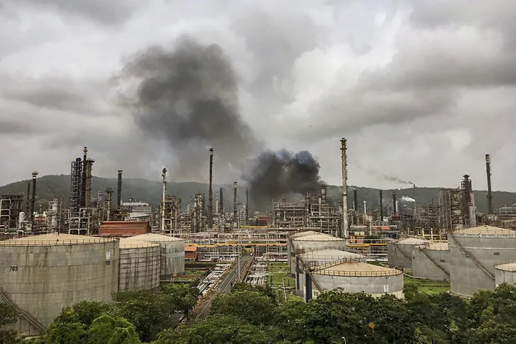 Smoke is seen after a fire broke out at a refinery of...- India TV Hindi