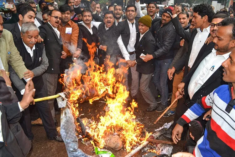People burn a Pakistani flag during a protest against the...- India TV Hindi