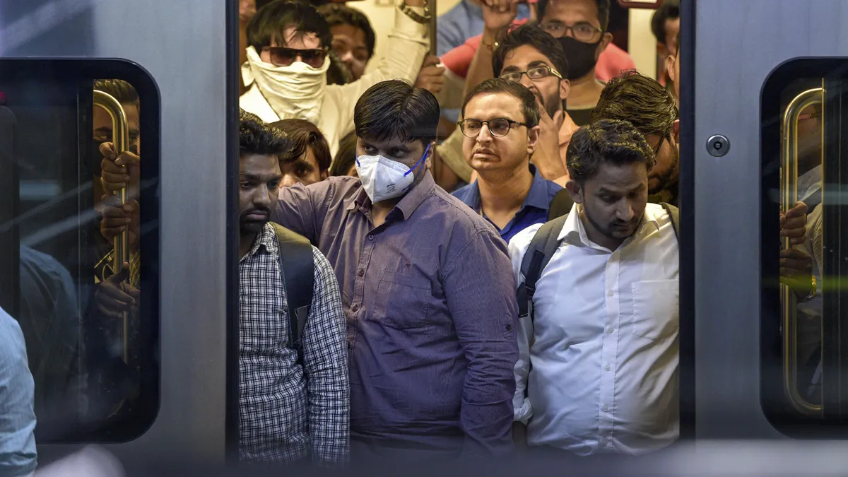 Passengers wear masks to mitigate the coronavirus pandemic...- India TV Hindi