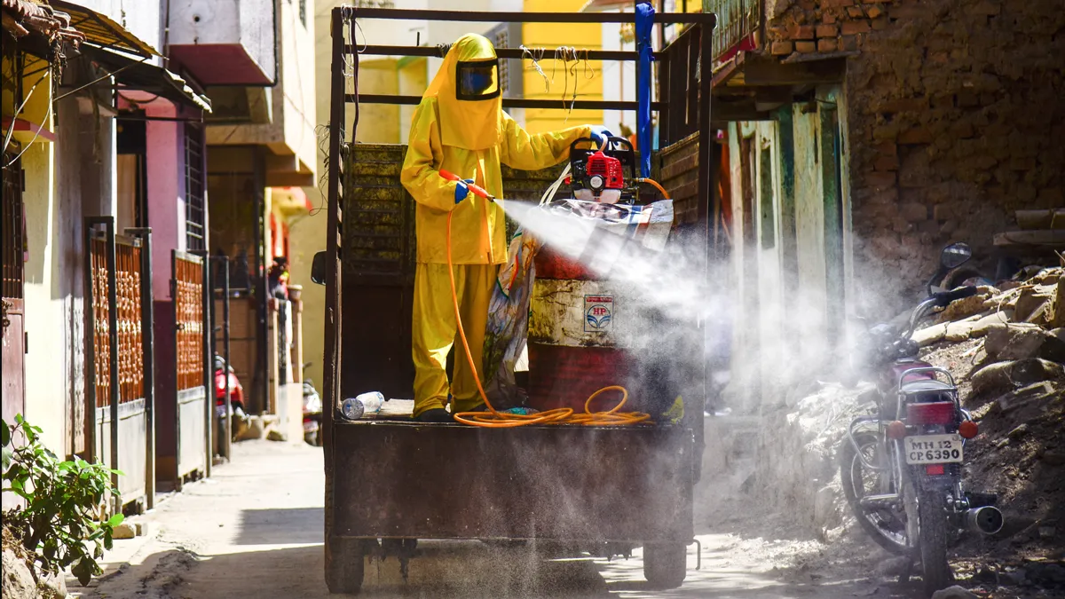 Workers spray disinfectant in a residential area to contain...- India TV Hindi