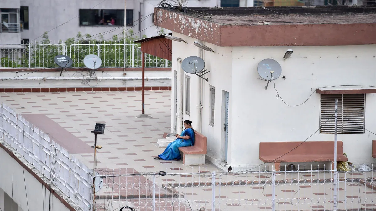 Kolkata: A woman with her mobile on the roof of her house...- India TV Hindi