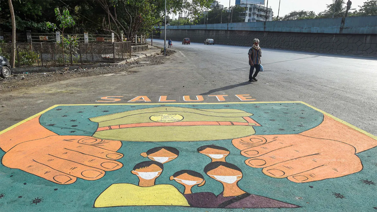 Mumbai: A man walks past a street art dedicated to police...- India TV Hindi