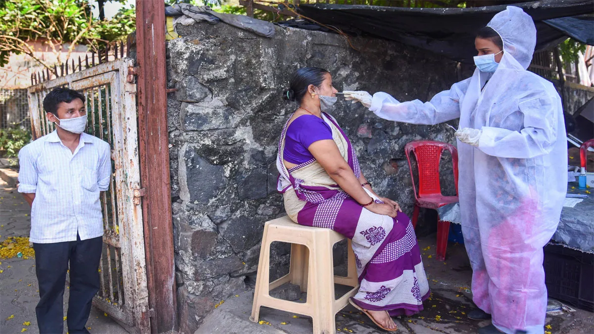 Mumbai: A medic conducts COVID-19 testing at Valmiki Nagar...- India TV Hindi