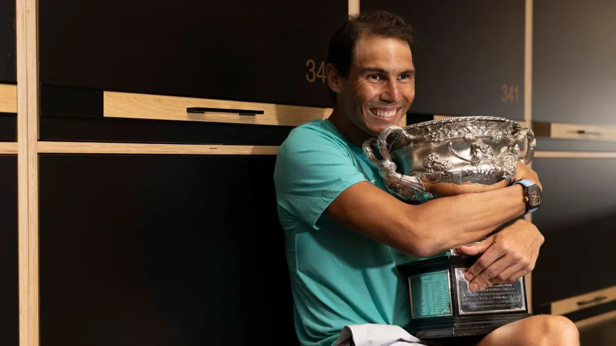 Rafael Nadal poses with the Australian Open men's singles final trophy in the locker room following - India TV Hindi