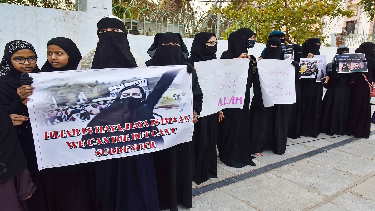 Muslim women holding placards participate in a mass prayer congregation, in solidarity with Muslim g- India TV Hindi