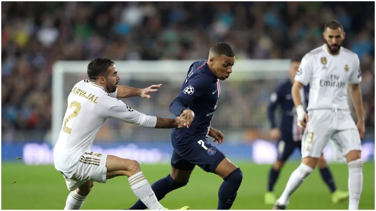 Kylian Mbappe of Paris Saint-Germain runs with the ball past Daniel Carvajal of Real Madrid (File)- India TV Hindi