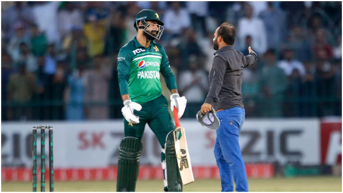 Multan Pakistans Shadab Khan, left, looks toward a fan who ran onto the field during the second ODI- India TV Hindi