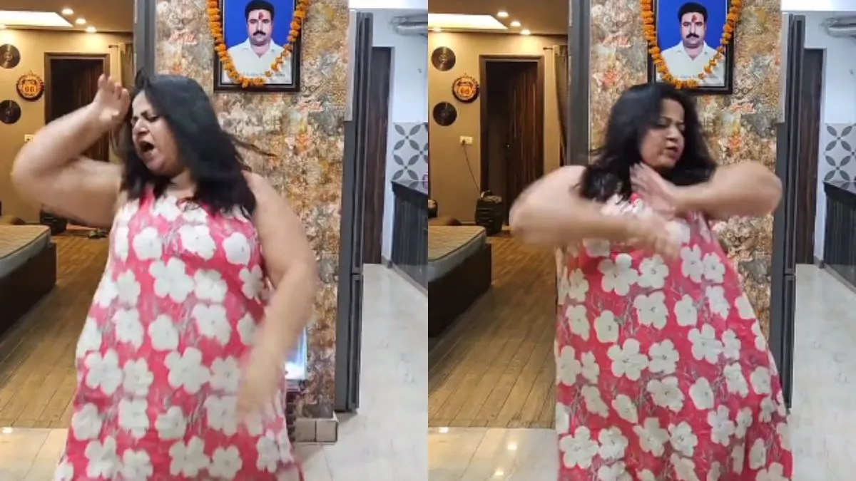 मृत पति की तस्वीर के सामने नाचते हुए महिला।- India TV Hindi