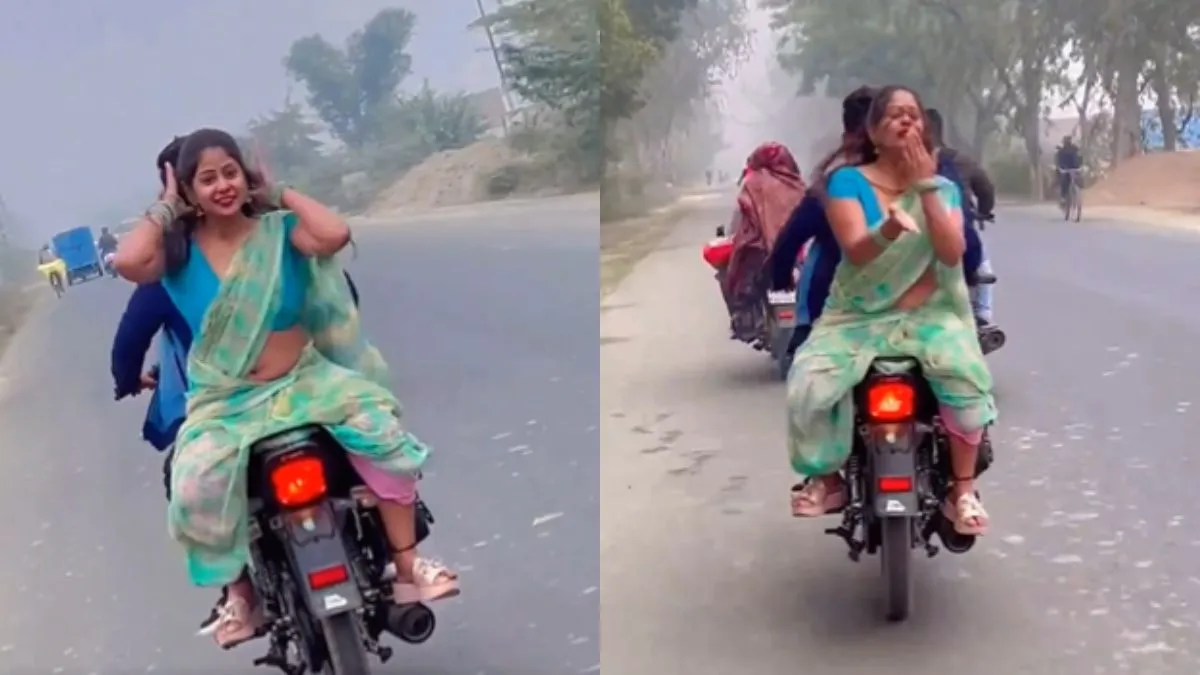 बाइक पर बैठ लोगों को फ्लाइंग किस देते हुए महिला।- India TV Hindi