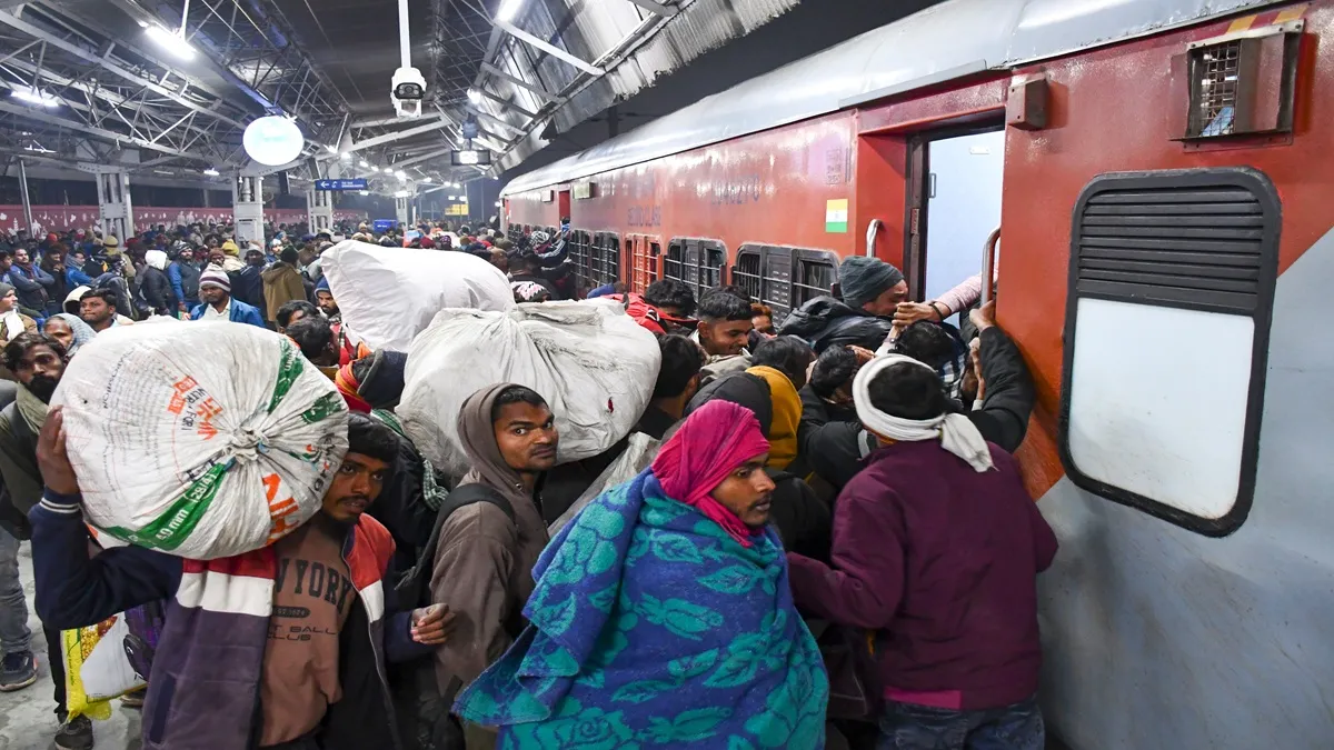 Rail passenger boarding the train at the railway station.