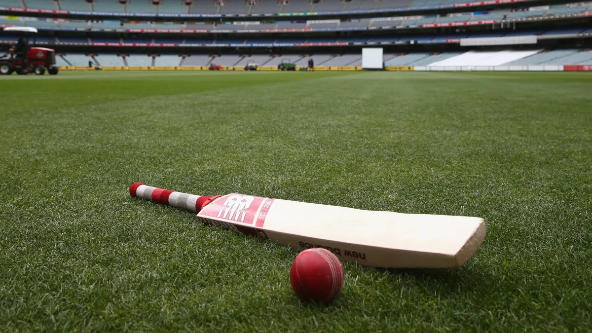 Bat and ball placed on the cricket field