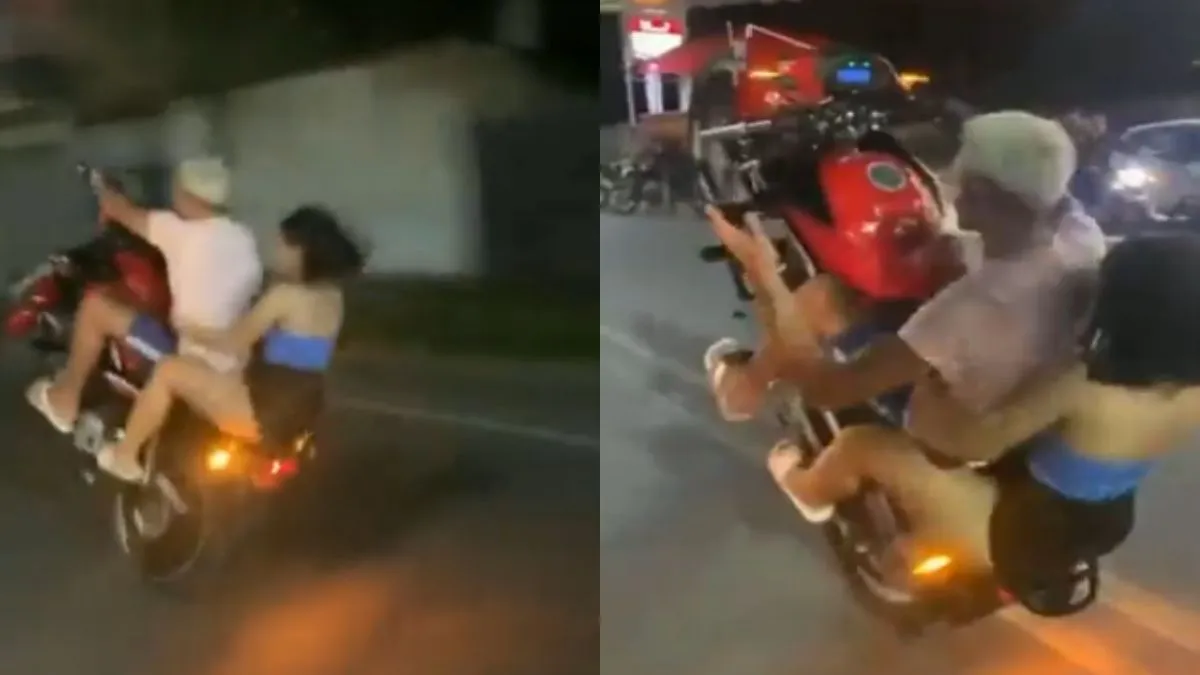 Casal sentado na bicicleta durante o golpe