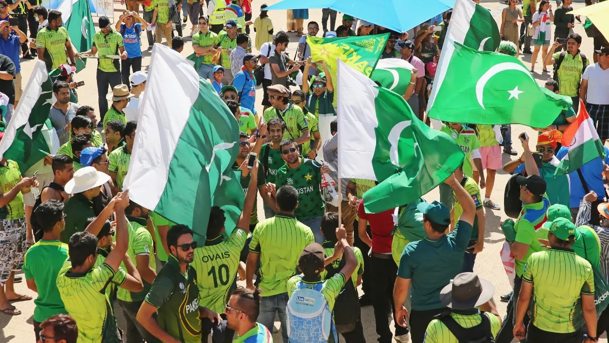 Pakistan cricket fans holding hand flag
