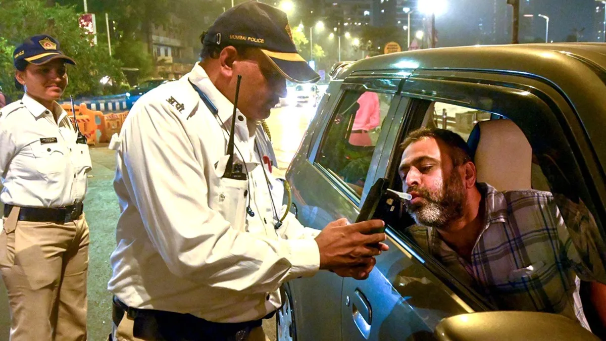 एक कार चालक की अल्कोहल जांच करते ट्रैफिक पुलिस अधिकारी।- India TV Paisa