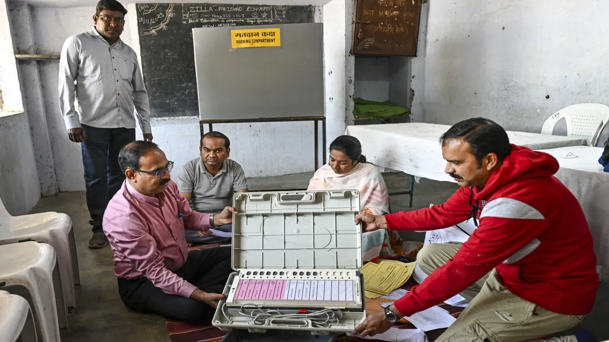 मतदान कक्ष में EVM खोलकर दिखाते चुनाव कर्मचारी- India TV Hindi