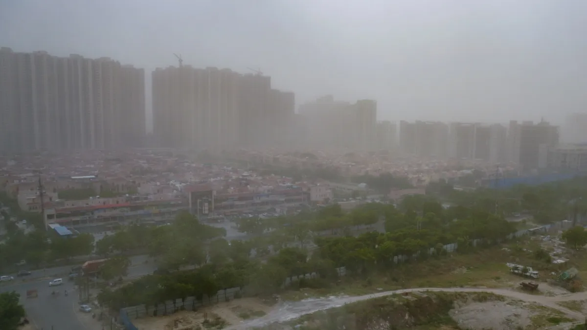 dust storm sweeps across the city, reducing visibility around residential buildings, in Noida, Monda- India TV Hindi