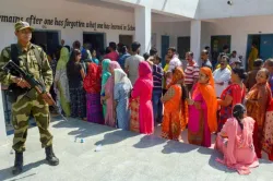 <p>A security personnel stands guard as people wait in...- India TV Hindi