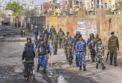 Security personnel patrol a violence-affected area- India TV Hindi