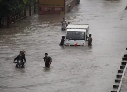 Commuters push their vehicle down the waterlogged Delhi Gurugram Expressway service road after rainf- India TV Hindi