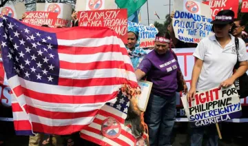 women group in manila burns american flag with photo of...- India TV Hindi