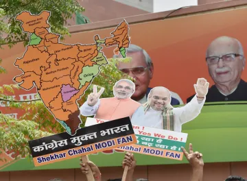 <p>BJP workers display the cut-outs of PM Narendra Modi and...- India TV Hindi
