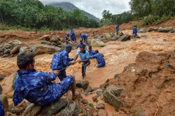 Kerala Flood:Rescue workers search for the bodies of missing persons after a landslide, triggered by- India TV Hindi