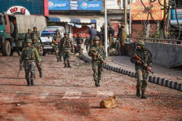 <p>Army personnel patrol a street during a curfew, imposed...- India TV Hindi