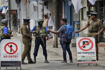 <p>Sri Lankan policemen check the identity card of a person...- India TV Hindi