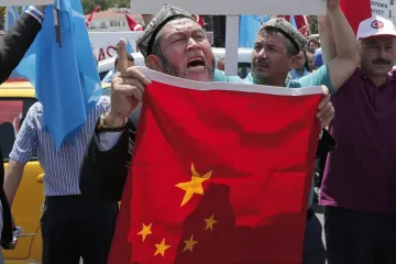 Uighurs living in Turkey and Turkish supporters, chant slogans as they hold a Chinese flag | AP File- India TV Hindi