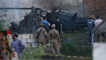 Pakistan army officials examine the site of a plane crash in Rawalpindi, Pakistan.- India TV Hindi